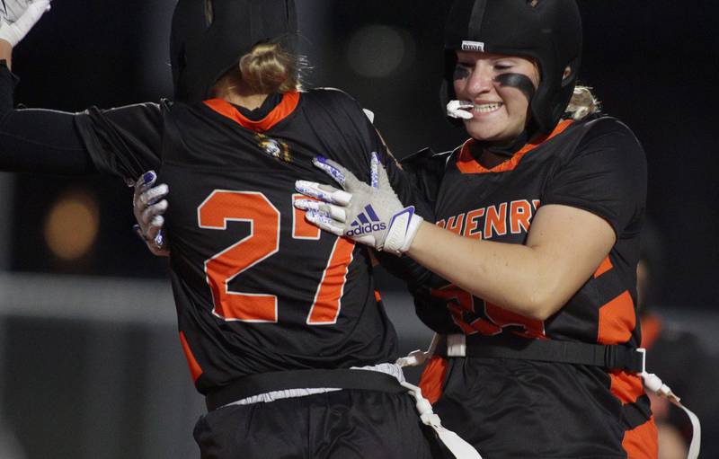 McHenry’s Chloe Casey, left, is greeted by Madalynn Sima after a touchdown against Antioch in IHSA Regional Title Game action flag football at McHenry High School in McHenry on Thursday, Oct. 10, 2024.