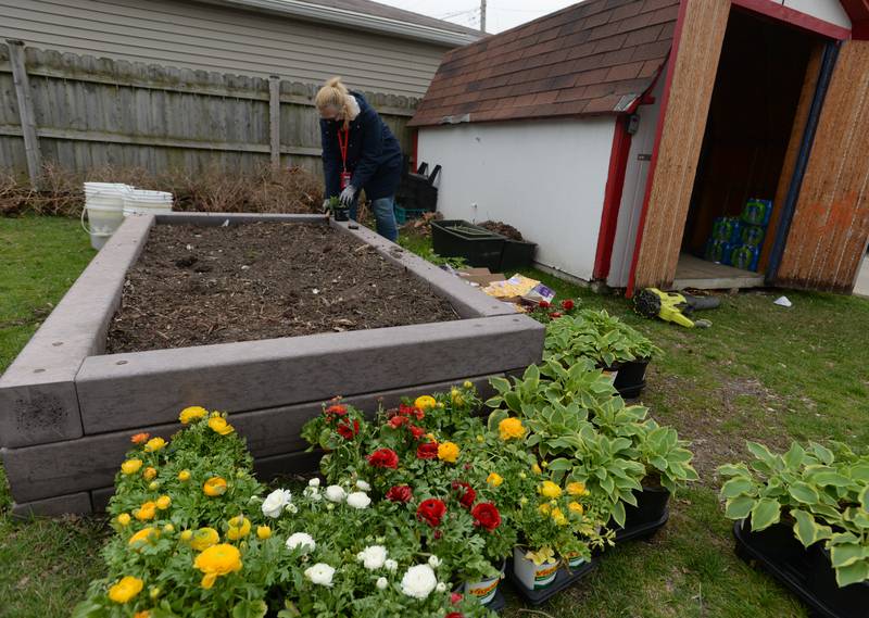 Heritage Middle School Instructional Special Ed Science teacher Sister Sharon Dillon plants flowers in the garden that was started with the help of her students.  The garden  then created a collaboration with Home Depot and the school's OAV Club to initiate the beautify day held Wednesday April 20, 2022.