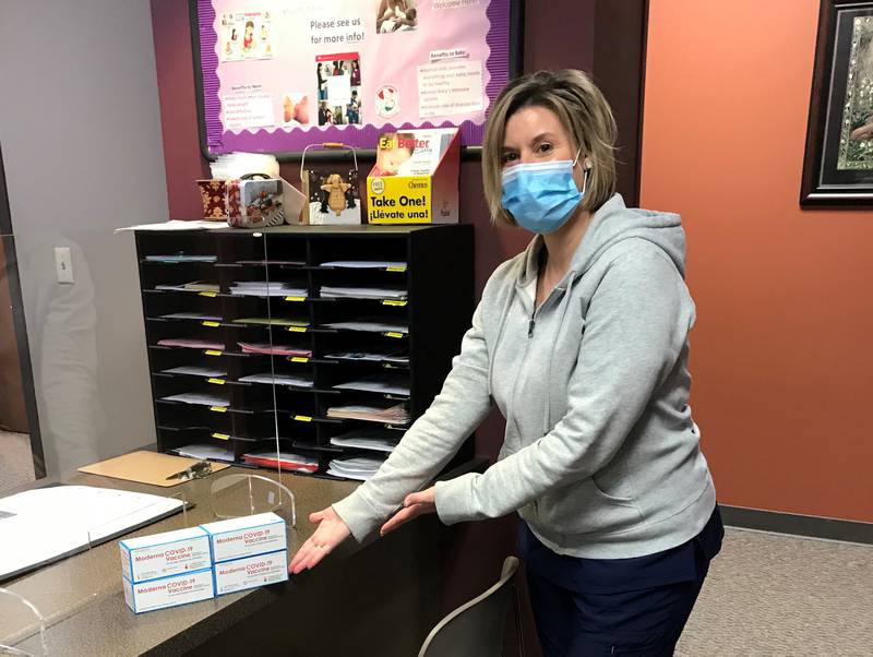 A Kendall County Health Department staff member displays a portion of the first shipment of the Moderna COVID-19 vaccine received by the department on Monday, Dec. 28.