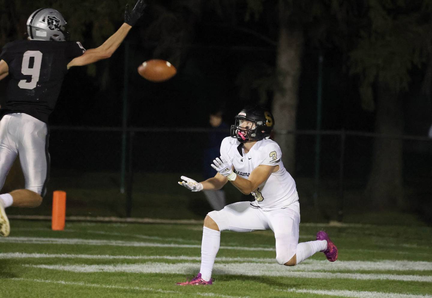 Sycamore's Carter York catches a touchdown pass as the ball just gets by Kaneland's Carter Grabowski during their game Friday, Oct.4, 2024, at Kaneland High School in Maple Park.