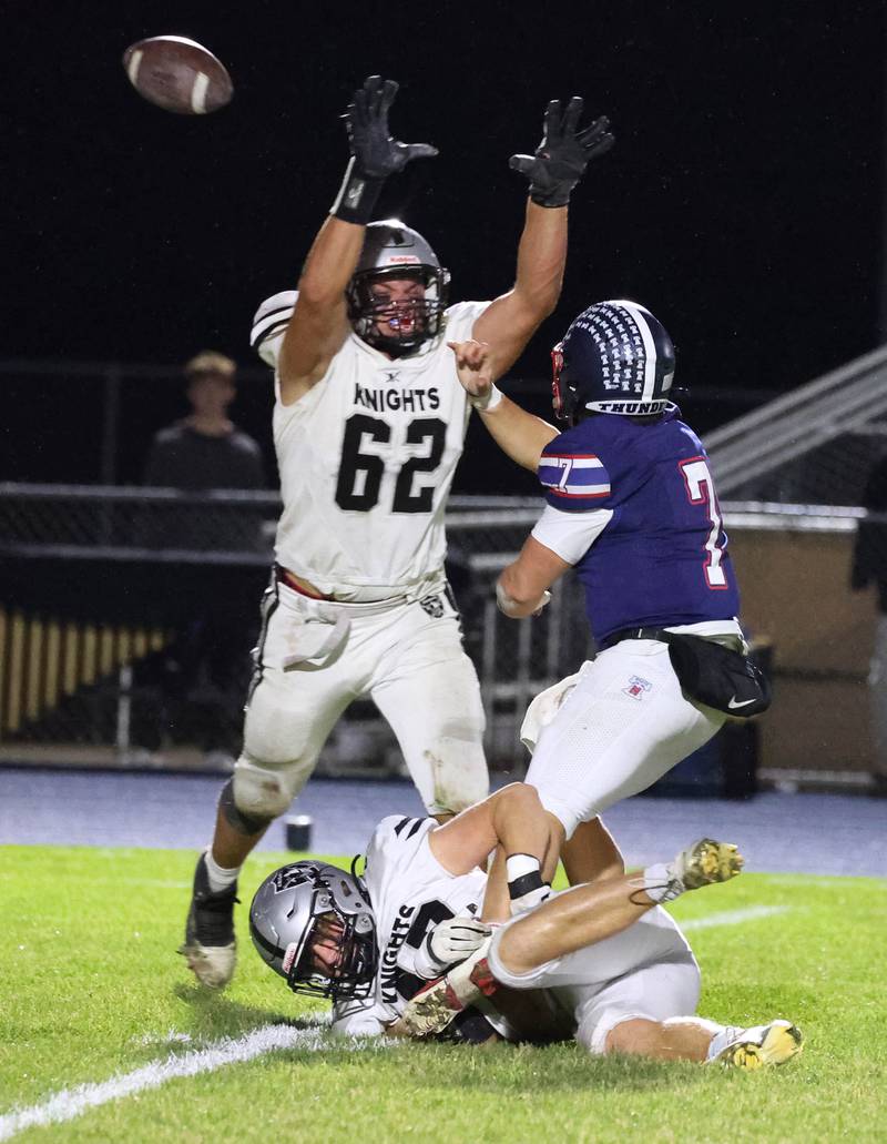 Belvidere North quarterback Andrew Bucci gets the ball past Kaneland's Jake Buckley despite being in the grasp of Kaneland's Brady Valentini Friday, Nov. 7, 2025, during their Class 5A second round playoff game at Belvidere North High School. The play was ruled a sack.