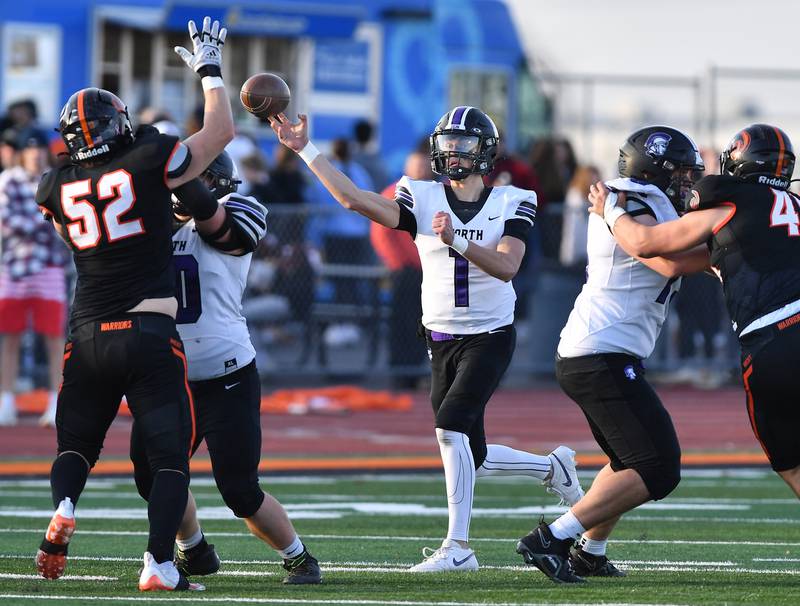 Downers Grove North quarterback Owen Lansu (1) fires a pass as Lincoln-Way West's Nick Kavooras tries to block it during an IHSA Class 7A quarterfinal game on Nov. 11, 2023 at Lincoln-Way West High School in New Lenox.