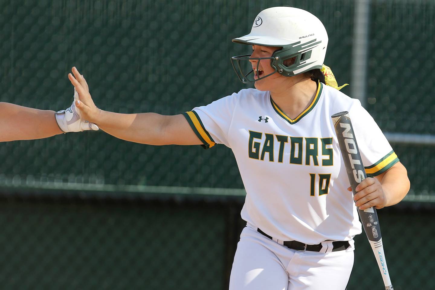 Crystal Lake South's Alexis Pupillo gets a high-five from teammate Molly Cook after scoring against Woodstock North during their IHSA Class 3A Softball regional championship at Crystal Lake South High School on Thursday, June 3, 2021 in Crystal Lake. Crystal Lake South won 8-0 through 7 innings of play.
