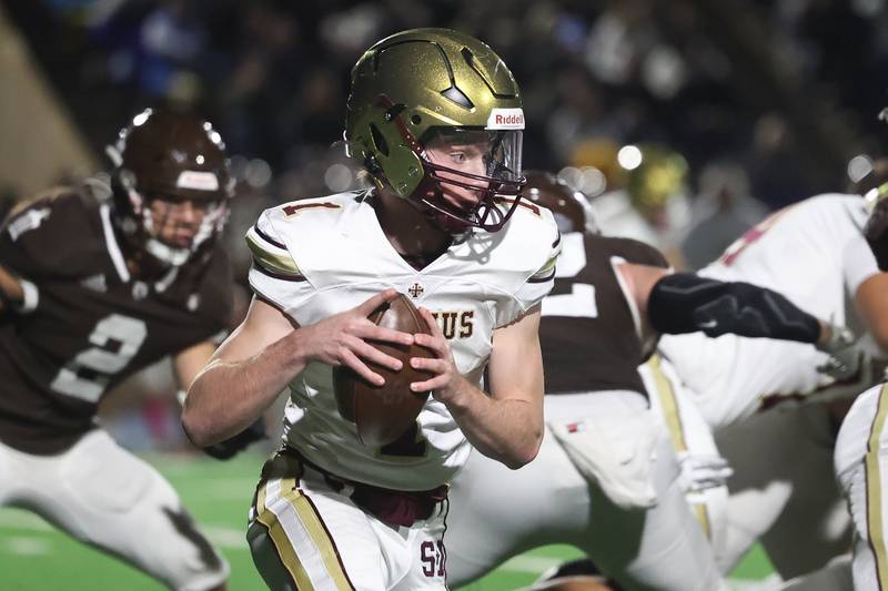 St. Ignatius’ Jack Wanzung rolls to the outside against Joliet Catholic on Friday, Oct. 20 in Joliet.