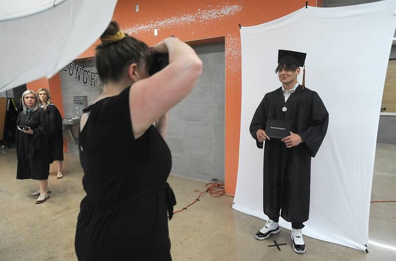 Nico Acevedo has his photograph taken by Clare Britt on Saturday, May 14, 2022, during the graduation ceremony at Crystal Lake Central High School.