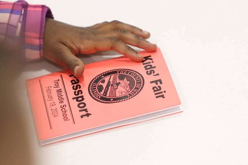 Kids use passport to check in at various vendors to receive gifts at the Will County Executive 2024 Kids’ Fair at Troy Middle School in Plainfield on Monday, Feb. 19, 2024.