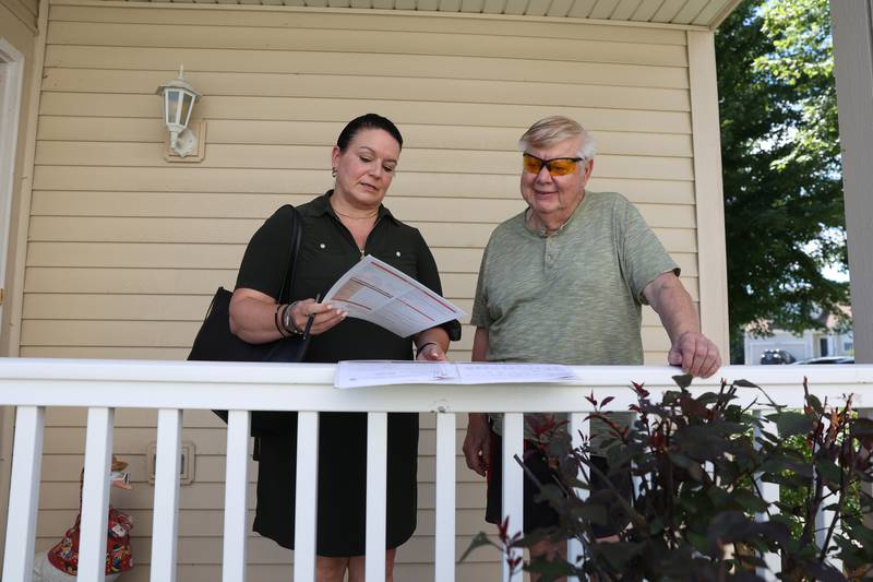 Maria Cedano, a realtor with ReMax, goes over paperwork with her client Wayne Galasinski. Wayne is looking to downsize and sell his home he has had since 2003 Wednesday, Aug. 10, 2022, in Crest Hill.