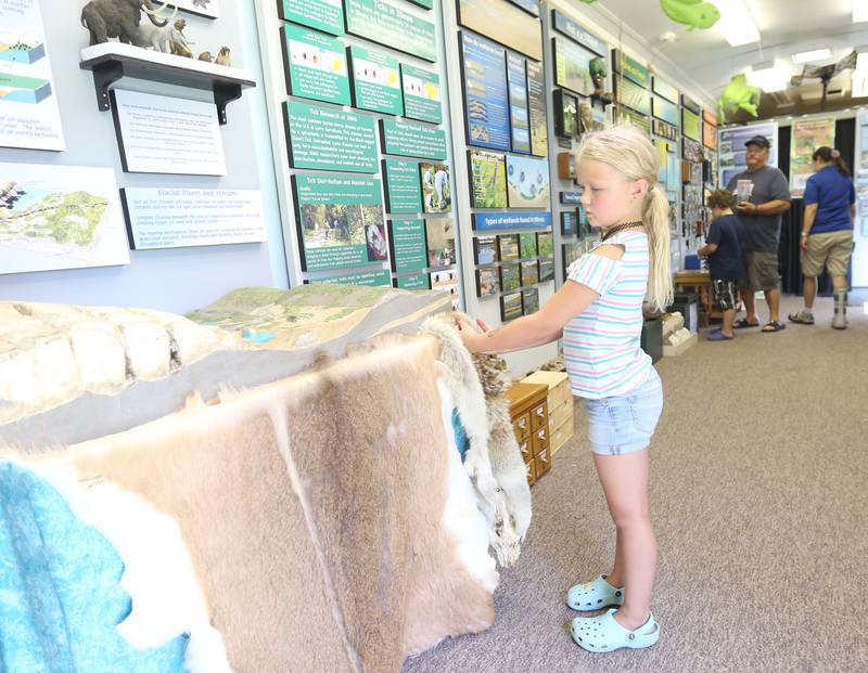 Myka Lydia, of Granville, explores The Illinois Natural History Survey Traveling Science Center on Tuesday, July 30,  2024 at Hopkins Park in Granville.
The Illinois Natural History Survey Traveling Science Center is a 320-square-foot mobile classroom featuring informative, engaging exhibits on biodiversity and natural resources that visits schools and communities across Illinois.
Visitors learn about the types of habitats and species diversity of their region, as well as ways to protect against threats to that diversity.
Since 2006, the center has visited more than 150 communities and 200 public events while providing structured school programs for up to 30,000 students each year. Sponsors are North Central Bank, Granville National Bank, Boggios Orchard & Produce and Financial Plus Credit Union.