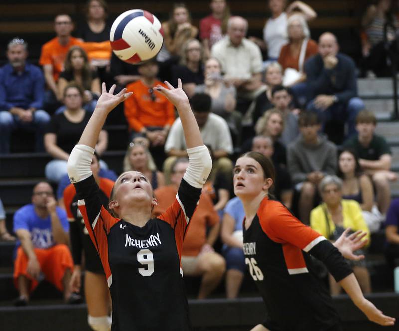 McHenry's Stella Murch sets the ball for her teammate, Teage Wings during a Fox Valley Conference volleyball match on Thursday, Aug. 28, 2025, at the Freshman Campus of McHenry High School in McHenry.
