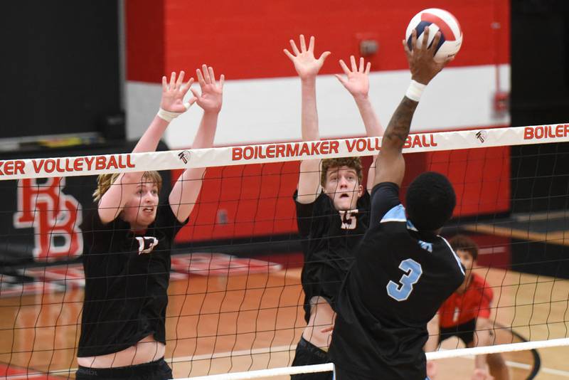 Bradley-Bourbonnais' Jason Parker, left, and Owen Kilpatrick, center, defend a hit from Kankakee's Jamon Barlow during a game at Bradley-Bourbonnais Thursday, April 9, 2026.
