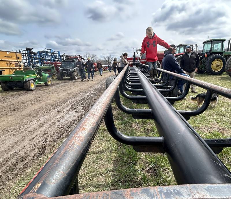 Cayson Wolf, 7, of Dixon, climbs on a round bale hauler on Saturday, April 5, 2025 at the Hazelhurst Spring Consignment Auction. Cayson was at the sale with his dad.