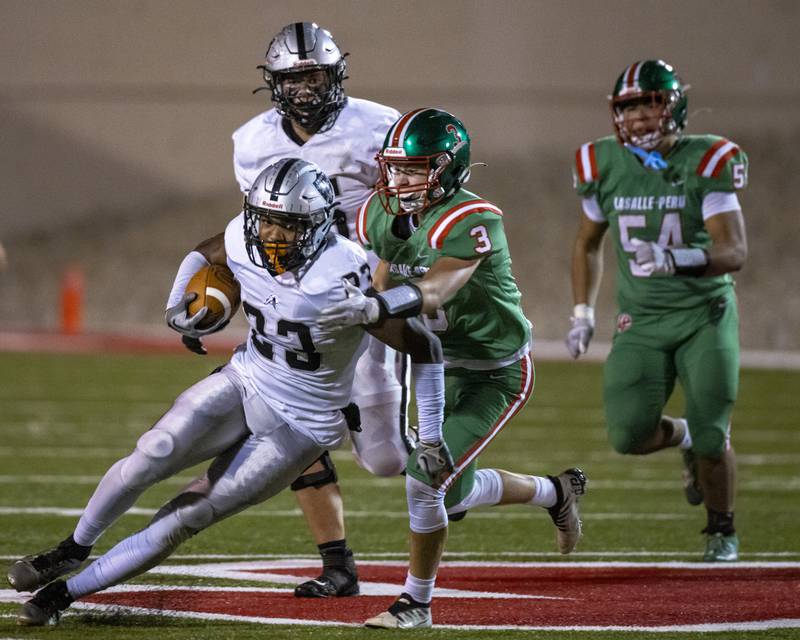 Michael Hartman of Lasalle Peru attempts to corral Kaneland's Aric Johnson during the game at Howard Fellows Stadium on October 10, 2023.