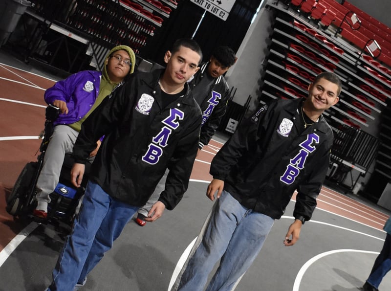 Participants pose for a photo at Safe Passage's annual Walk A Mile in Their Shoes event on April 18, 2026, at the Northern Illinois University Convocation Center in DeKalb. The event, held to raise awareness of sexual violence and supoprt survivors, was hosted by the nonprofit as part of Sexual Assault Awareness Month.