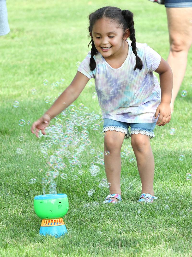 Olivia Meyers, 4, from DeKalb, plays in the bubbles Thursday, July 21, 2022, during the DeKalb Chamber of Commerce Family Fun Fest at Hopkins Park in DeKalb.