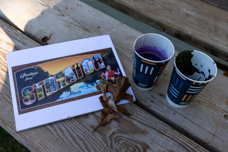 Blueprint of the Streator mural sits next to paint cups on scaffolding on Thursday, Sept. 11, 2025 at City Park in Streator.