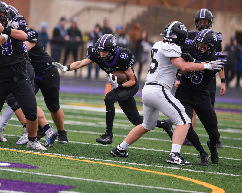 Downers Grove North's Oliver Thulin (10) zig zags to gain extra yards before being brought down by Fenwick's Josh Morgan (26) during the second week of the class 7A game held on Nov. 9, 2024, held at Downers Grove North.