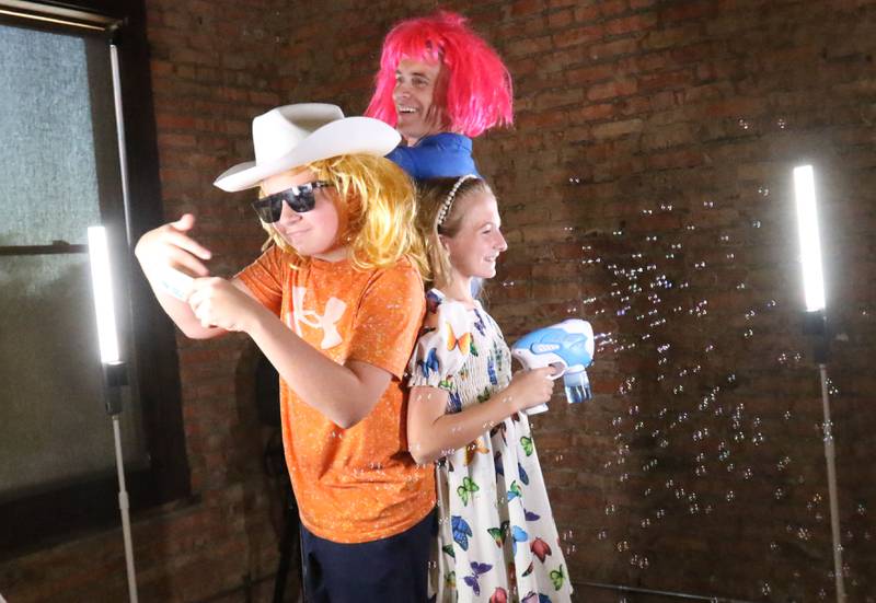 Asher, Avalen and Andy Arnold, owner of Andys Pet Shop, have their photo taken for a 360 camera during the second annual Best of the Illinois Valley event on Thursday at the Auditorium Ballroom in La Salle.