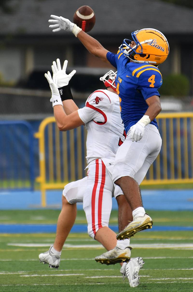Lyons Township’s Anthony Pearson (4) tries to break up a pass for Hinsdale Central’s Jack Lesniewicz who made the catch for a big gain during a game on September 20, 2025 at Lyons Township High School in LaGrange.