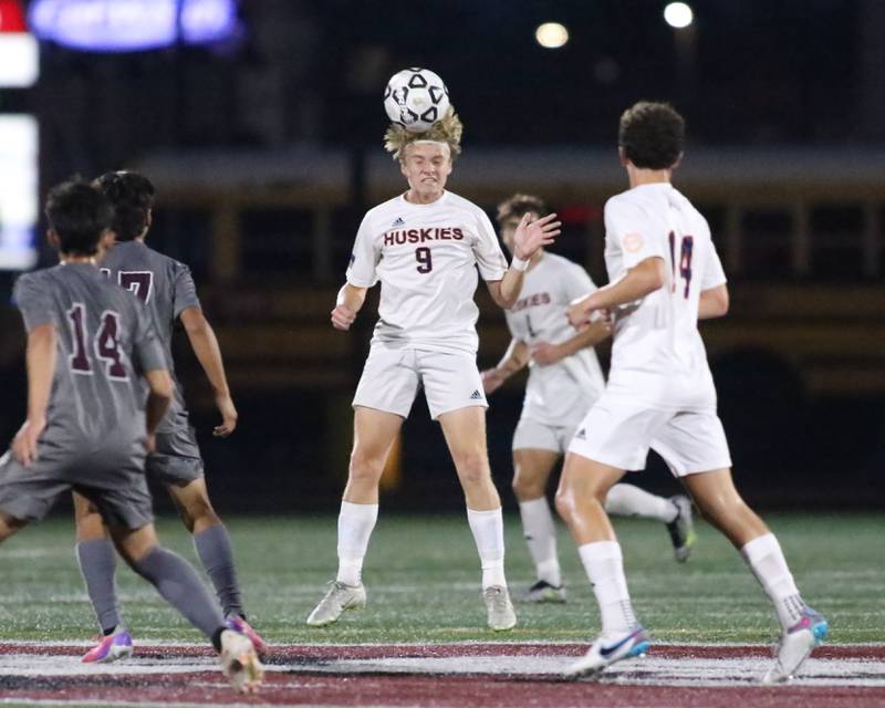 Naperville North's Josh Pedersen (9) heads the ball during soccer match between Naperville North at Morton.  Sept 21, 2023.