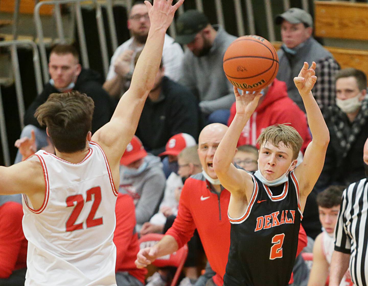 DeKalb's Sean Reynolds (2) sinks a 3-point basket over the outstretched hand of Streator's Christian Benning (22) on Saturday, Jan. 22, 2022, at Pops Dale Gymnasium.