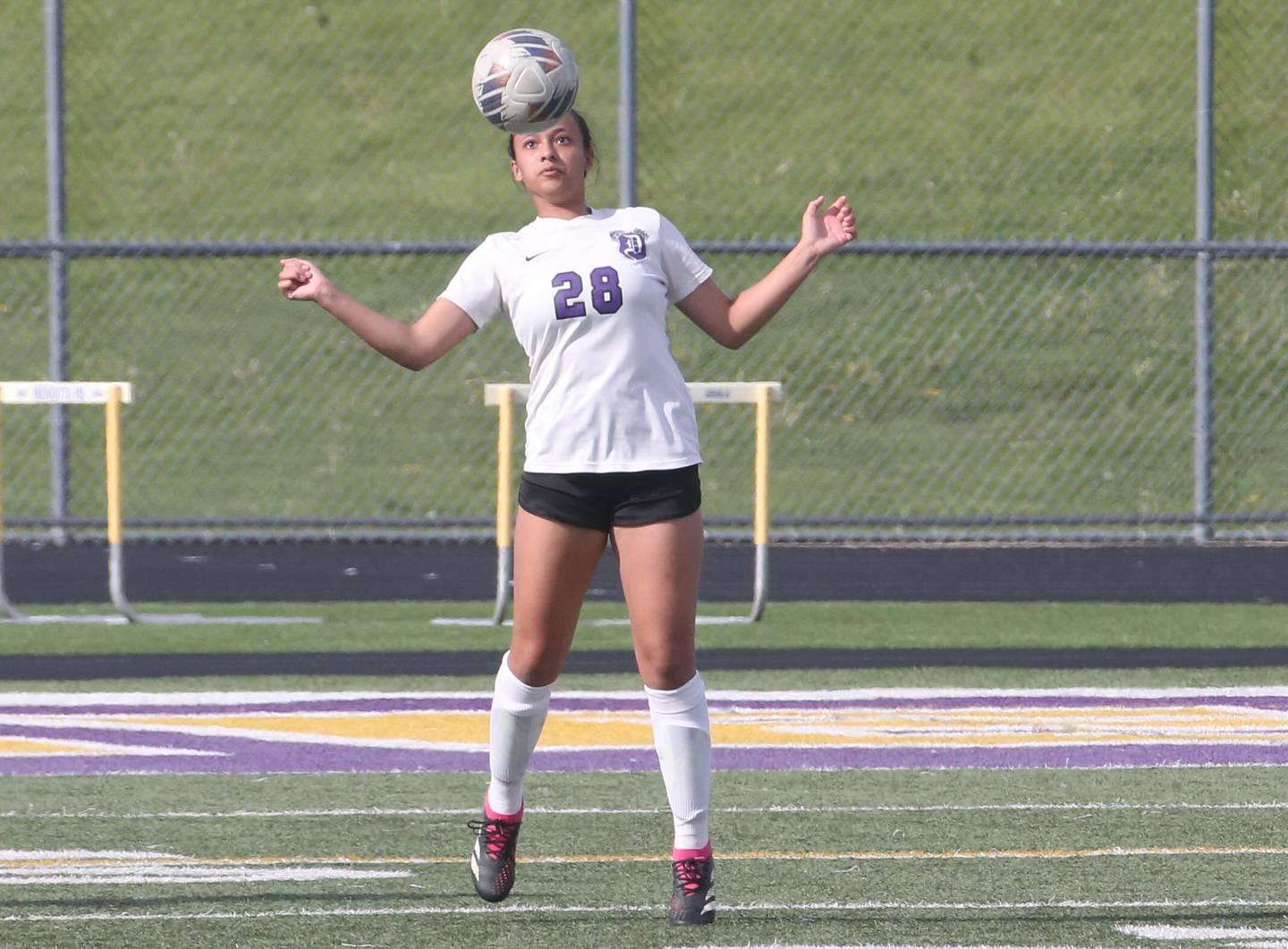 Dixon's Kamille Prather applies a headder to the ball against Mendota on Wednesday, May 1, 2024 at Mendota High School.