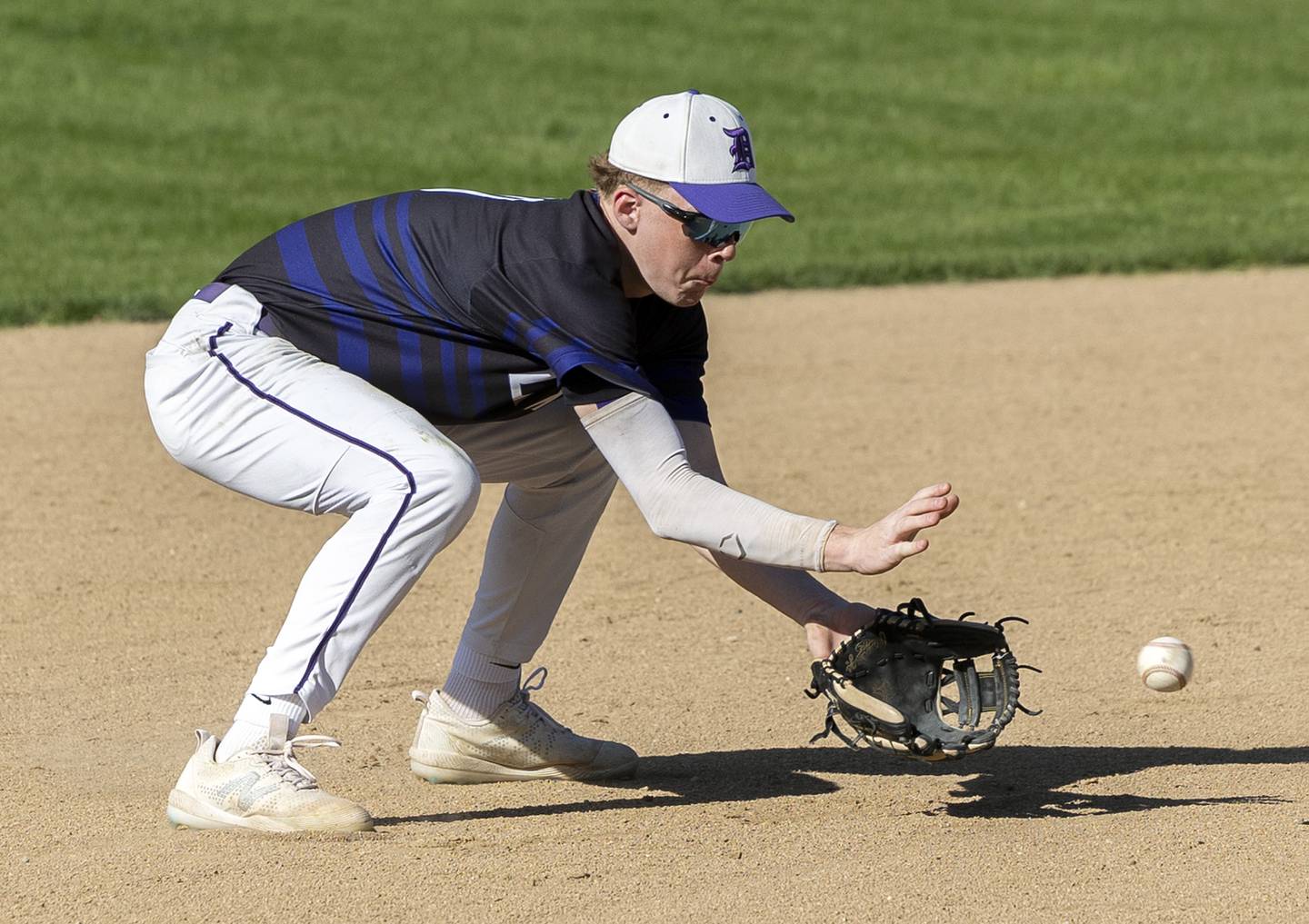 Dixon’s Jagger Kemp scoops a ball at short for an out against North Boone Tuesday, May 6, 2025.