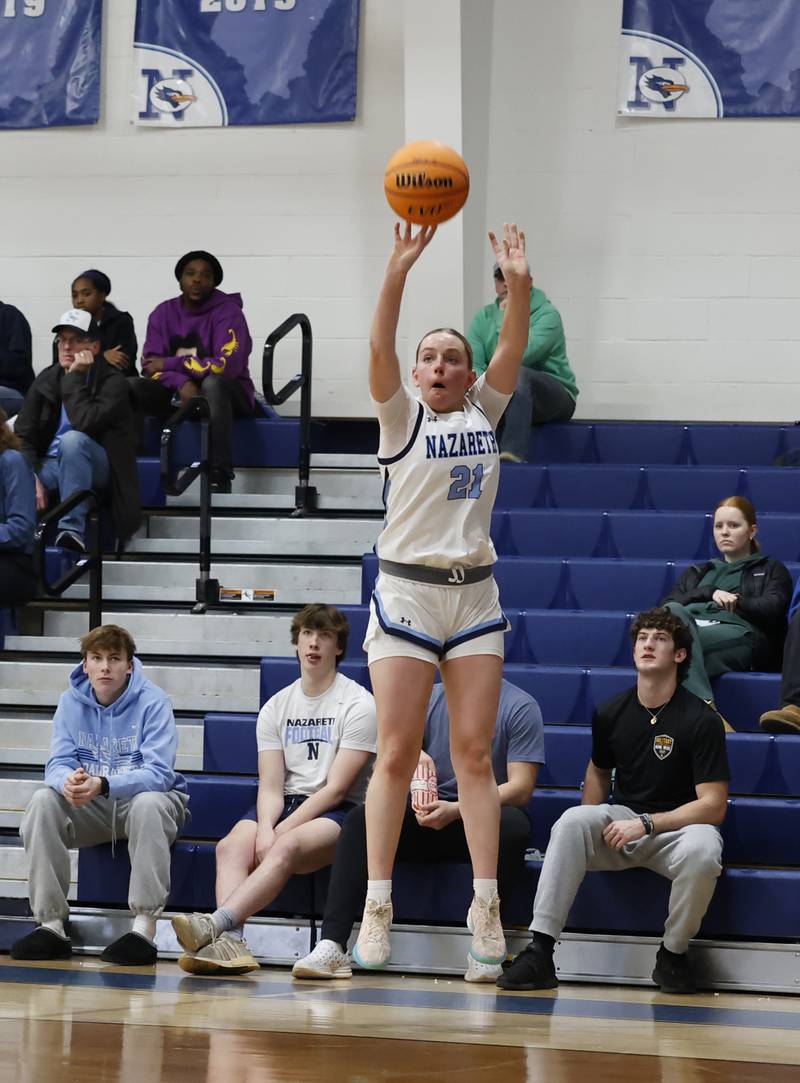 Nazareth's Lyla Shelton (21) takes a three-point shot during the girls varsity basketball game between Bolingbrook high school and Nazareth Academy on Monday, Jan. 12, 2026 in La Grange Park.