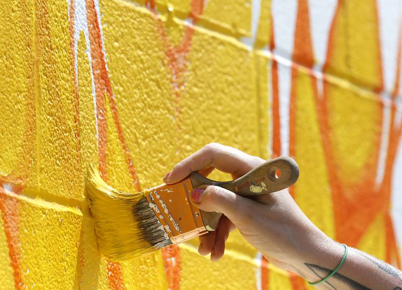 Melinda Cook paints mural on Thursday, June 19, 2025, on the side of the McHenry Brewing Co., in McHenry. This is one of two new McHenry murals in McHenry.