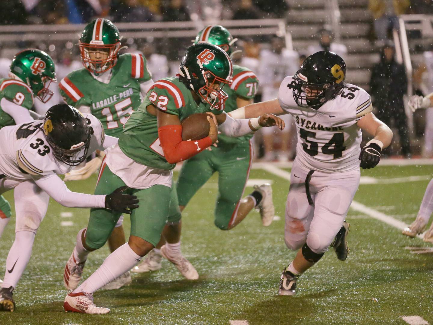 L-P's Maalik Madrigal (22) runs the ball past Sycamore's Joseph Culotta (33) on Friday, Oct. 14, 2022 at Howard Fellows Stadium in Peru.