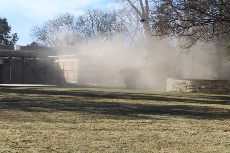 Dust plumes over the the St. Mary's Episcopal Church property in Crystal Lake as the Academy Building, built in the 1850s, gets demolished on Jan. 13, 2026.