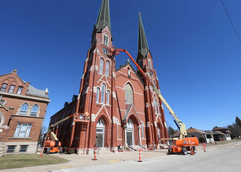 Workers tuckpoint spires on St. Hyacinth's Catholic Church on Tuesday, March 14, 2023 in La Salle. Last May, the church launched a $1.8 million capital campaign for a new roof, facade improvements and interior work.