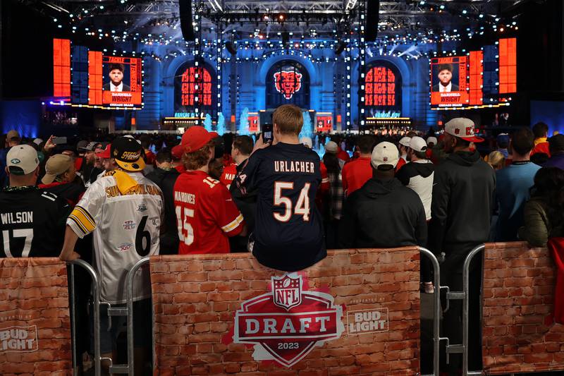 Arlo Collier, from Lawerence, Kansas, wears his Bears’ Urlacher jersey videoing the Bears 10th overall pick, tackle Darnell Wright of Tennessee, at the 2023 NFL Draft on Thursday, April 27, 2023 in Kansas City, MO.
