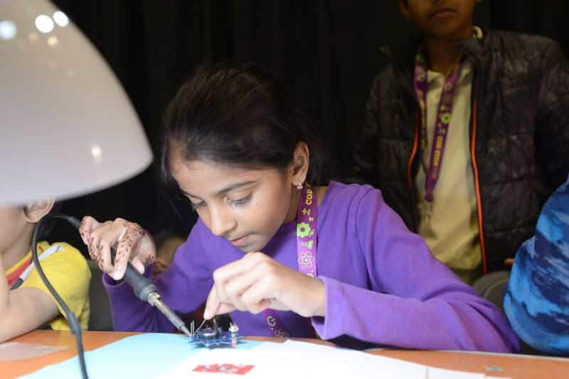 Shasta Madan Kumar of Westmont creates an atom pin  during the STEMCON event on Saturday April 26, 2025 at the College of DuPage in Glen Ellyn.