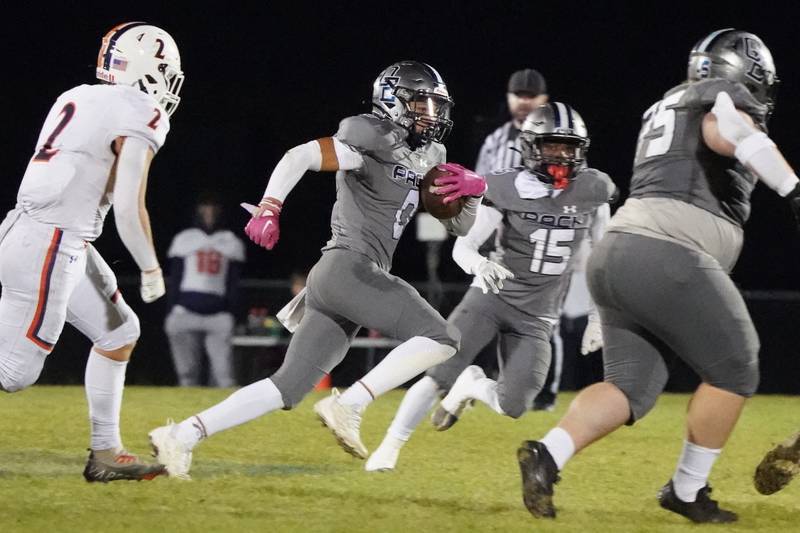 Oswego East's Kameron Williams (0) runs after intercepting a pass against Oswego during a football game at Oswego East High School on Friday, October 25, 2024.