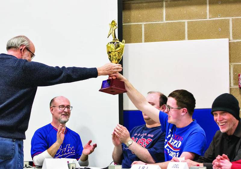Elliott Frankfother receives the first-place trophy for the Frankfother Family Team on Saturday after they kept a three-peat just out of Miller & Lancaster grasp during the Stupor Bowl at Reagan Middle School in Dixon.