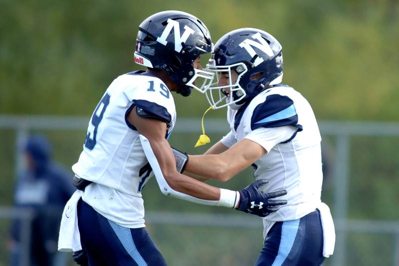 Nazareth’s Jake Cestone, right, is greeted by Trenton Walker after a Cestone touchdown against Prairie Ridge in first-round Class 5A playoff football action at Crystal Lake Saturday.