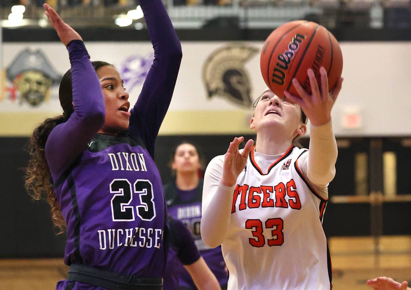 Crystal Lake Central's Katie Hamill goes to the basket against Dixon’s Ahmyrie McGowan during their Class 3A sectional semifinal Tuesday, Feb. 20, 2024, at Sycamore High School.