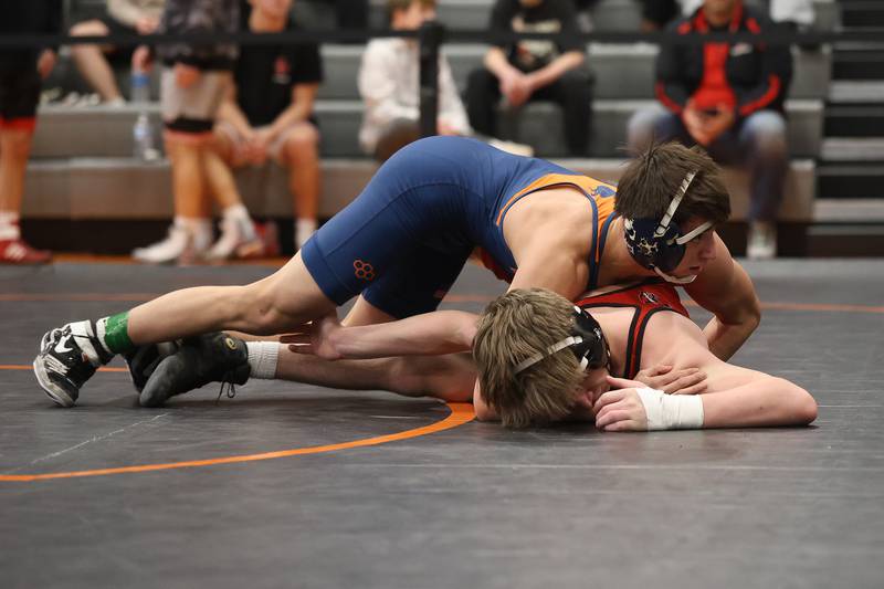 Oswego’s Aiden Ortiz gets over Yorkville’s Nolan Chrisse for the winning points in overtime in the SouthWest Prairie Conference 138 pound championship on Saturday, Jan. 24, 2026 in Minooka.