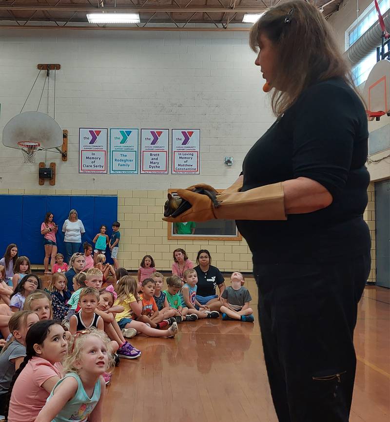 An African straw-colored fruit bat is held by Incredible Bats program director Sharon Peterson on Thursday, July 27, 2023, during a program sponsored by Reddick Library at the Ottawa YMCA.