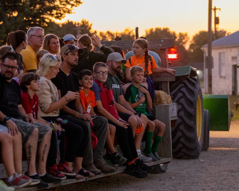 Families take haystack ride at the Monster Mash Balloon Bash on Saturday, Oct. 4, 2025 at the Bureau County Fairgrounds in Princeton.