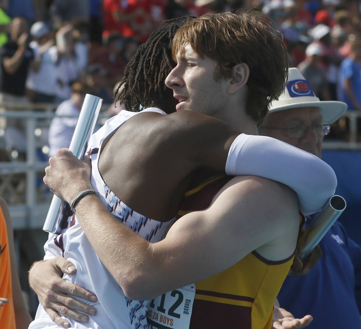 Kankakee’s Jyaire Hill and Richmond-Burton’s Jack Verdoni hug after finishing the 4 x 400 meter relay during the IHSA Class1A State Track and Field Championships Saturday, May 28, 2022, at Eastern Illinois University in Charleston.