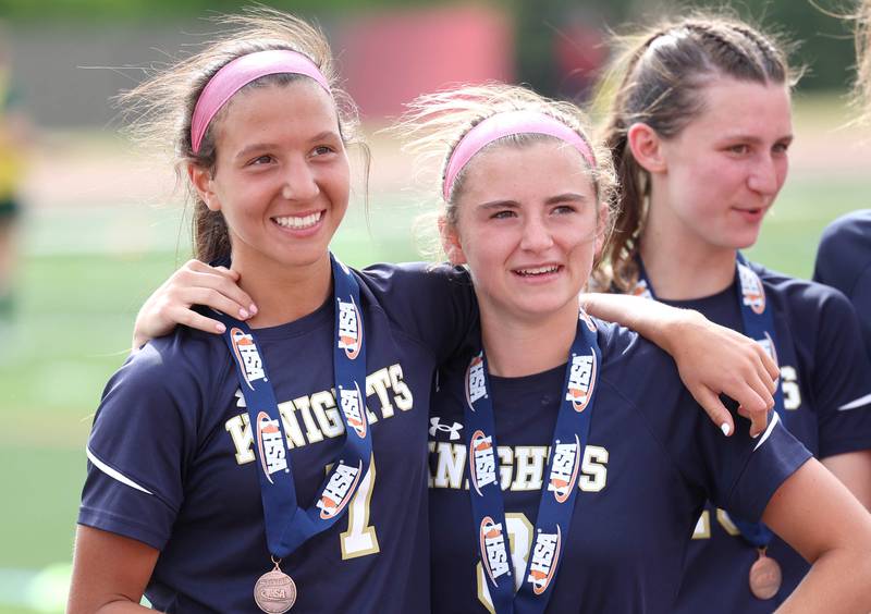 IC Catholic Prep's Grazie Narcisi (left) and Kelsey McDonough hug after receiving their fourth place medals after their loss to Pleasant Plains in the IHSA Class 1A state girls soccer third place game Saturday, May 27, 2023, at North Central College in Naperville.