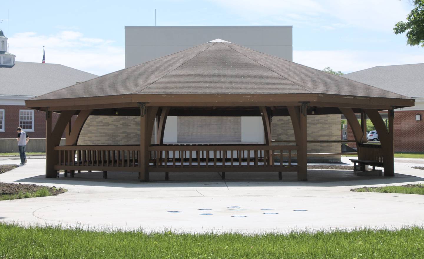 A splash pad, a ground-based jet sprayer for cooling off and recreation, sits in front of the gazebo and restroom facilities at Central Park in Sterling.