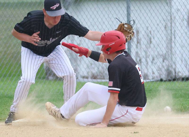 Henry-Senachwine's Jacob Miller slides safely into third base as Woodland's Hayden Marsinko misses the throw on Tuesday, May 12, 2026 at Woodland High School.