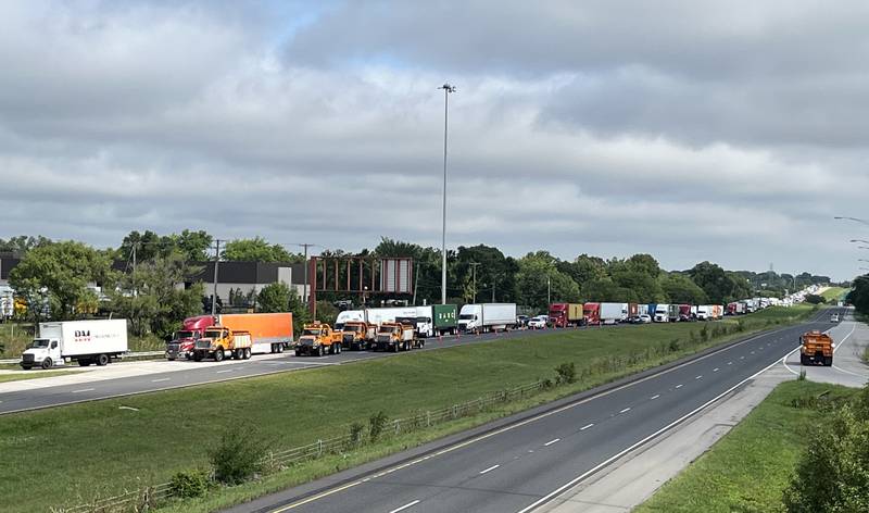 Semi-trailer trucks are backed up on southboud lanes of Interstate 55 near Channahon as vehicles are being rerouted because the interstate was blocked by storm damage and downed power lines Tuesday, July 16, 2024.