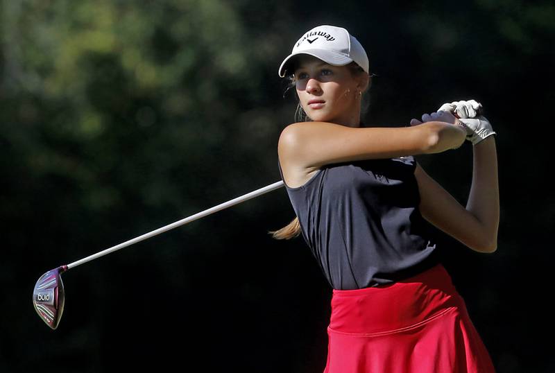 Huntley’s Kinsey Hayes watches her tee shot on the 5th hole during the Fox Valley Conference Girls Golf Tournament Wednesday, Sept. 25, 2024, at Crystal Woods Golf Club in Woodstock.