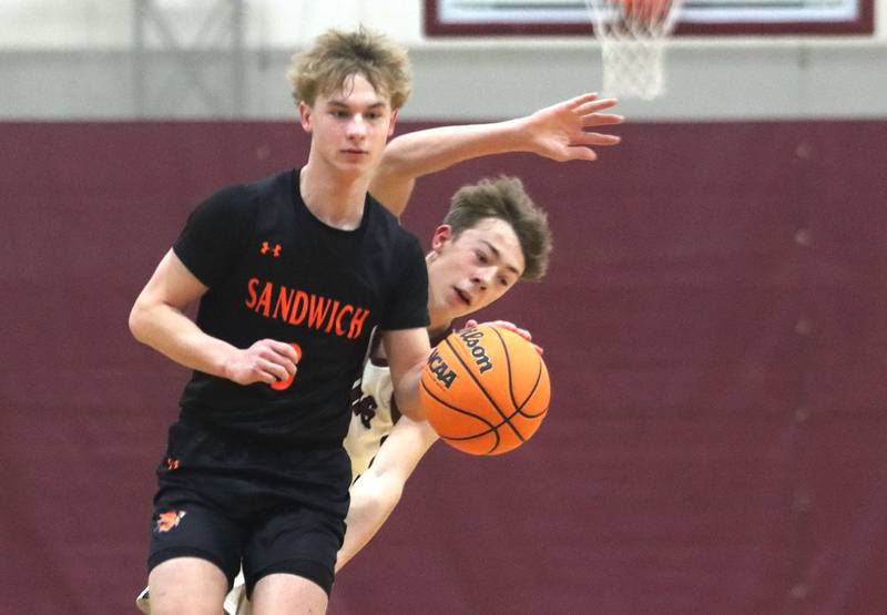 Sandwich’s Wyatt Koley scoots past Marengo’s Caden Bezik in varsity boys basketball action on Saturday, Jan..24, 2025, at Marengo High School in Marengo.