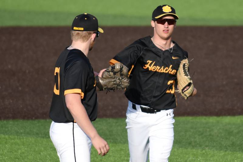 Herscher's Dylan Bayson, right, high fives Colton Carson after making a diving catch to end the sixth inning of a home game against Manteno Monday, May 11, 2026.