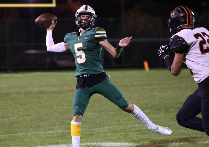 Waubonsie Valley’s Josh Siekierski throws a pass as DeKalb's Patrick Davis applies pressure during their game Friday, Oct. 11, 2024, at Waubonsie Valley High School in Aurora.