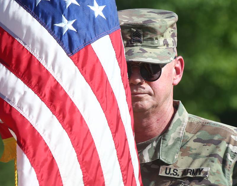 Joe Peshel with the United States Army, holds an American Flag on Flag Day, Tuesday, June 14, 2022 during a flag desecration ceremony at Veterans Park in Peru.